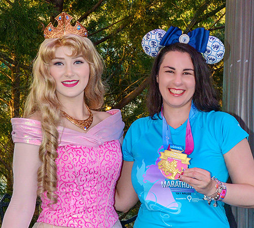Meeting Aurora at Disney World with rundisney princess half marathon medal